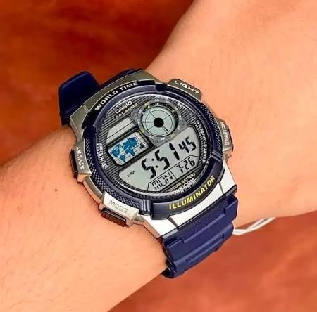 Digi Bear Casio Collection AE-1000W-2AVDF digital watch with a blue resin strap and world time display on a wrist
