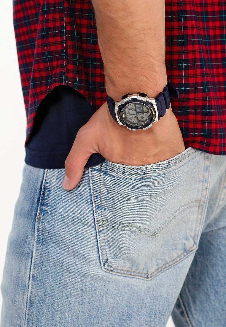 Digi Bear Casio Collection AE-1000W-2AVDF digital watch with a blue resin strap worn on a wrist