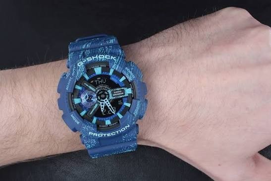 Digi Bear Casio G-Shock GA-110TX-2ADR blue resin sports watch with patterned strap worn on a wrist