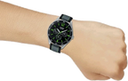 Digi Bear Casio Collection quartz watch with black dial, green accents, and grey fabric strap worn on a wrist