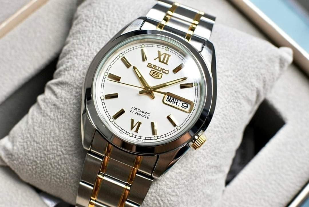 Digi Bear Seiko 5 automatic watch with a white dial, gold accents, and a two-tone stainless steel bracelet.