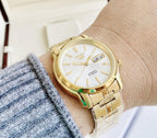 Digi Bear Seiko 5 SNKK74K1 automatic watch with a gold-tone stainless steel band and a white dial on a wrist