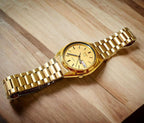 Digi Bear Seiko 5 SNXL72K1 automatic watch with a gold-tone stainless steel case, matching bracelet, and dial.