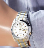 Digi Bear Seiko 5 SNKL57K1 automatic watch with a two-tone silver and gold stainless steel bracelet and white dial.